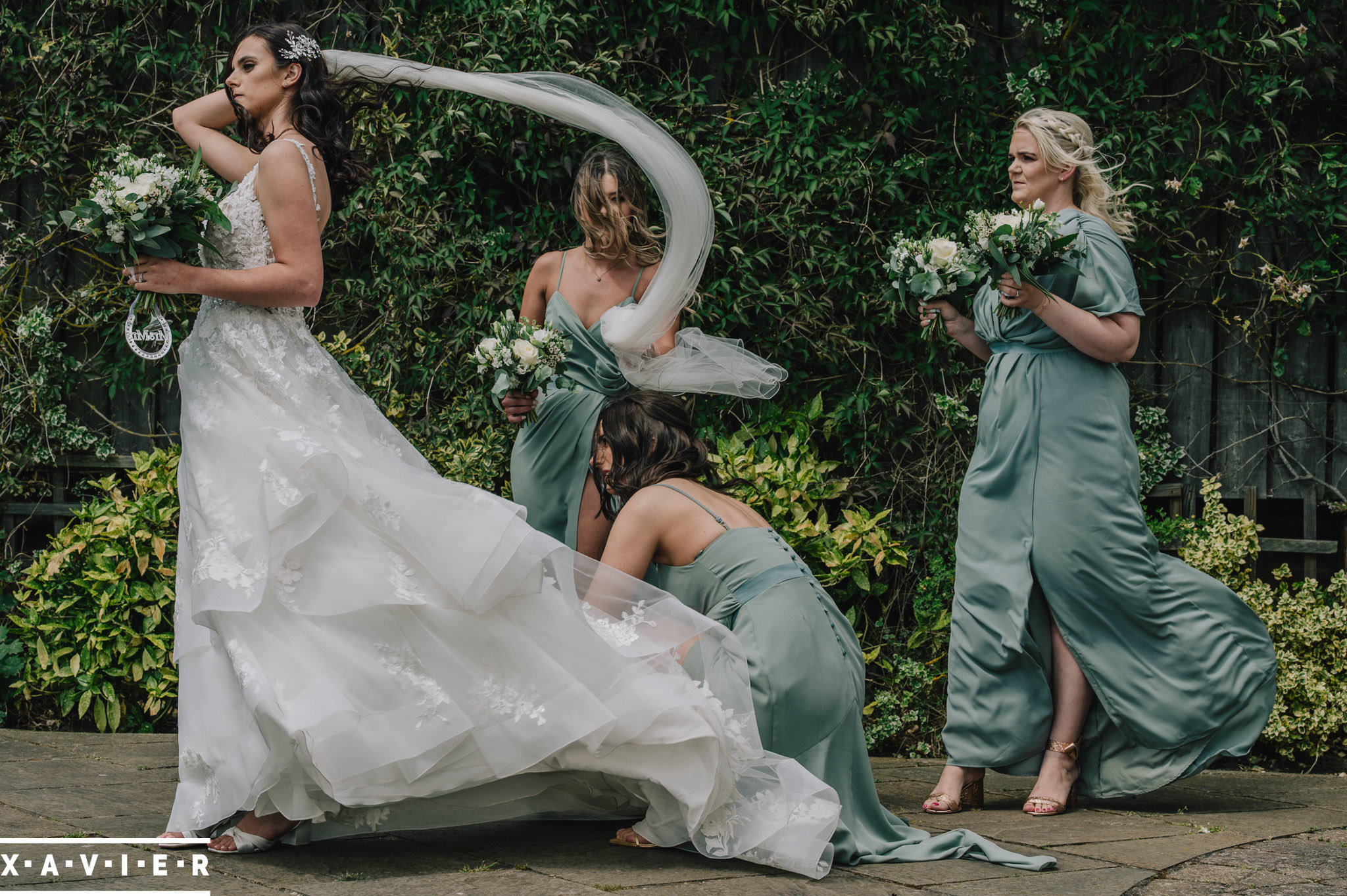 bridesmaids help arrnage the brides dress