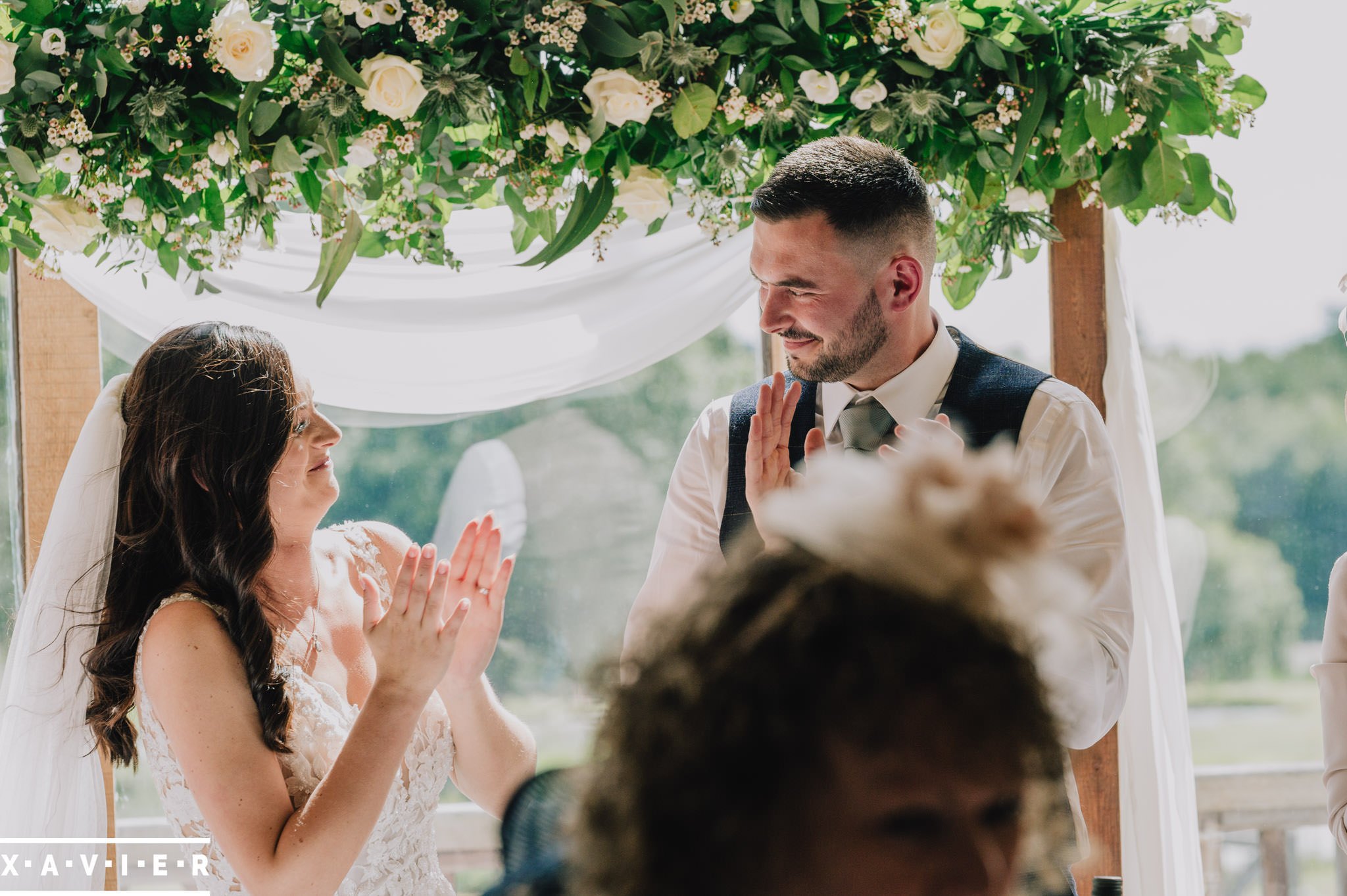 bride and groom clap each other during the speeches