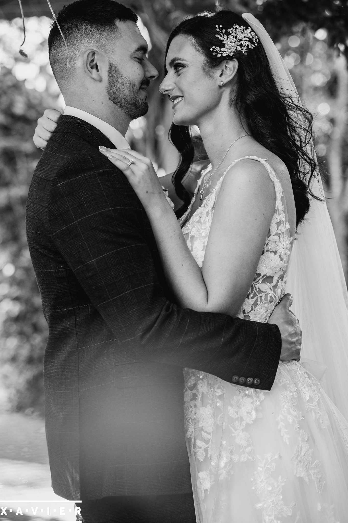 bride and groom iface each other on the woodland path