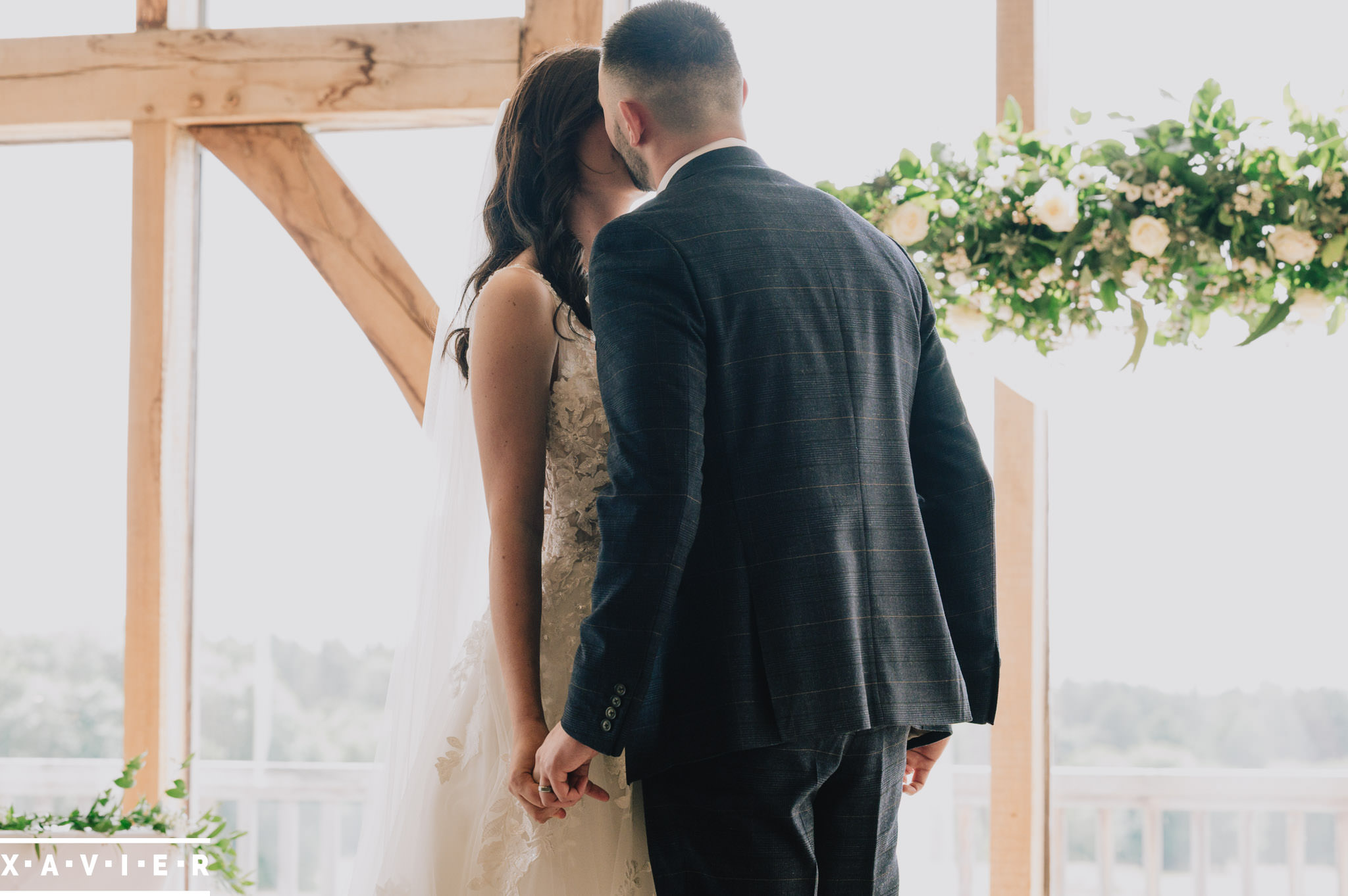 bride and groom have their first kiss