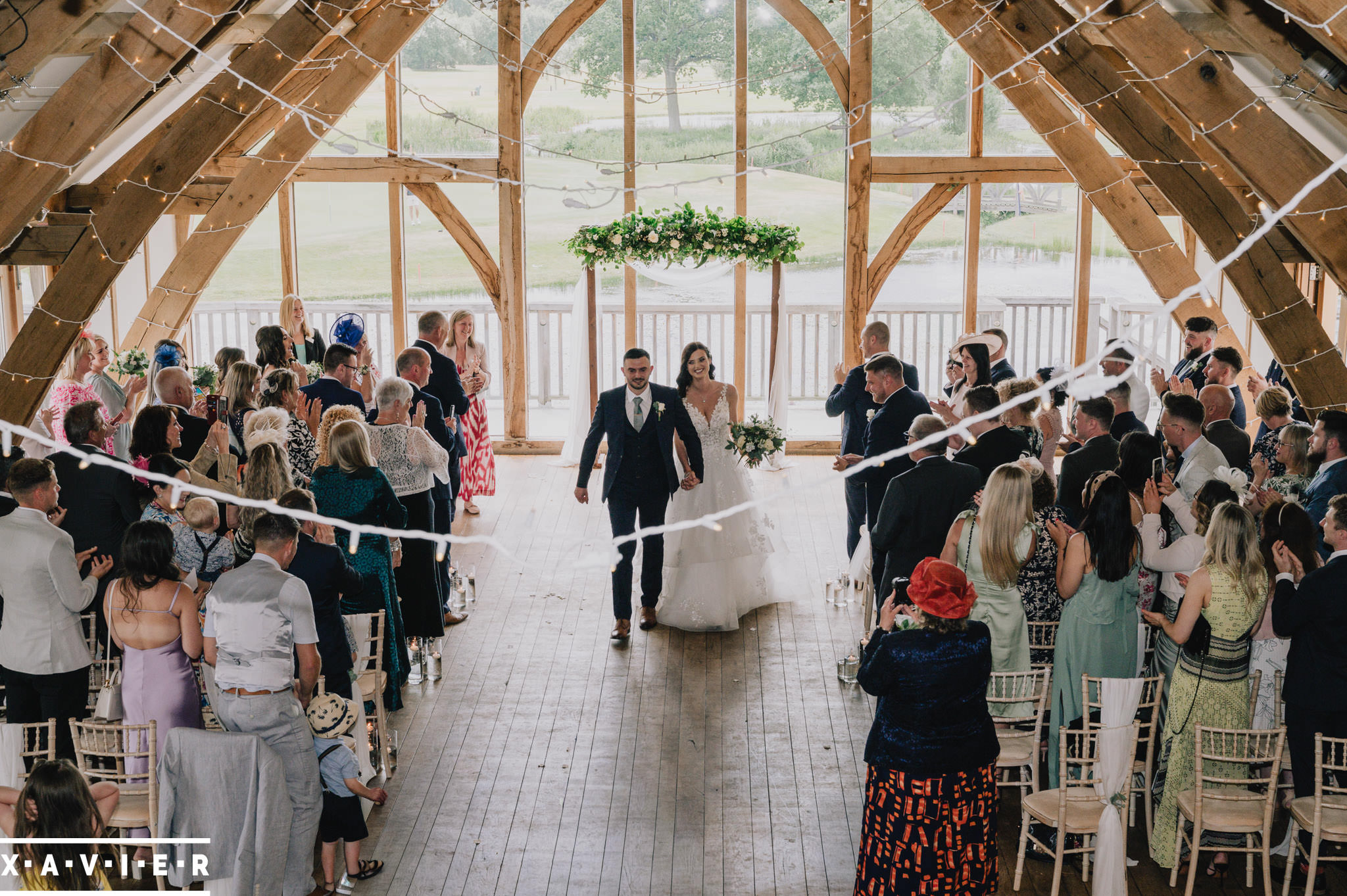 bride and groom leave the grand hall