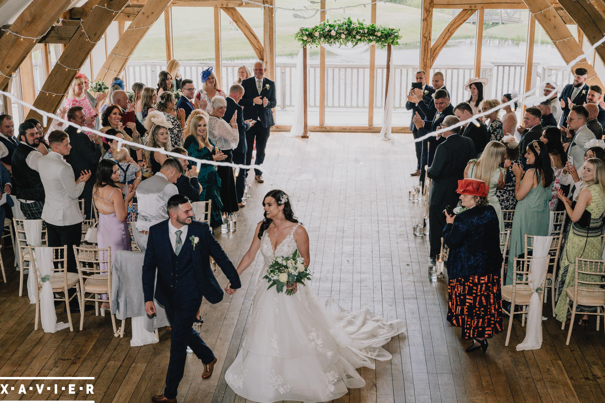 bride and groom walk hand in hand as they leave the ceremonyhand in hand