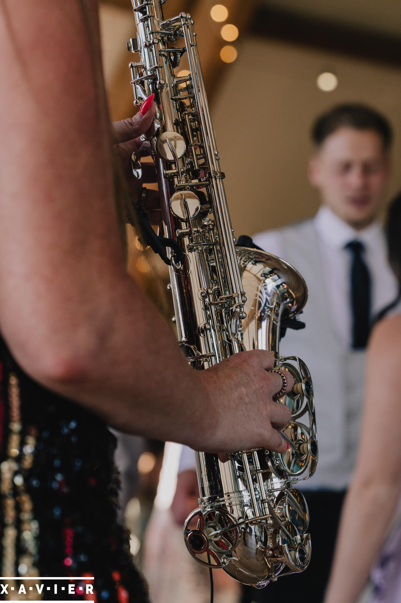 guests dance around the saxophone player