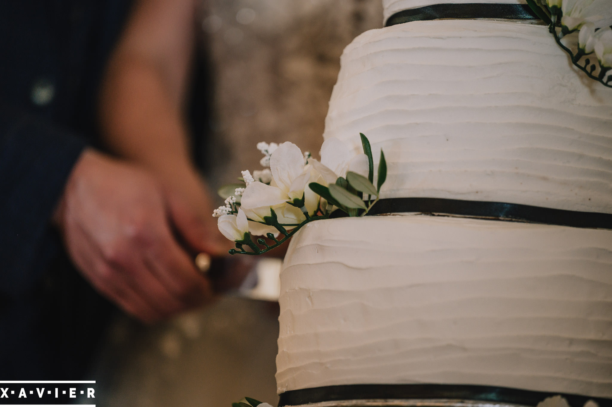 close up of the wedding cake being cut