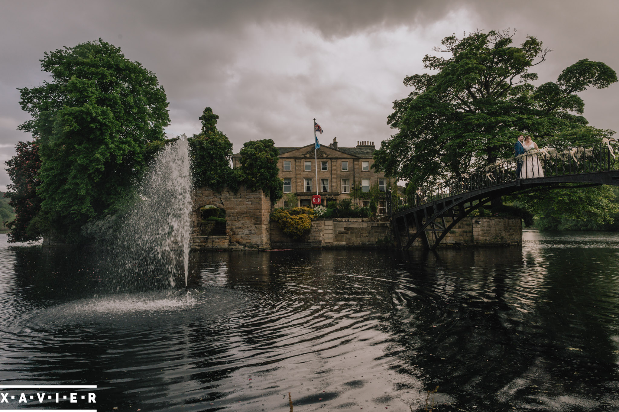 bride and groom on bridge walton hall