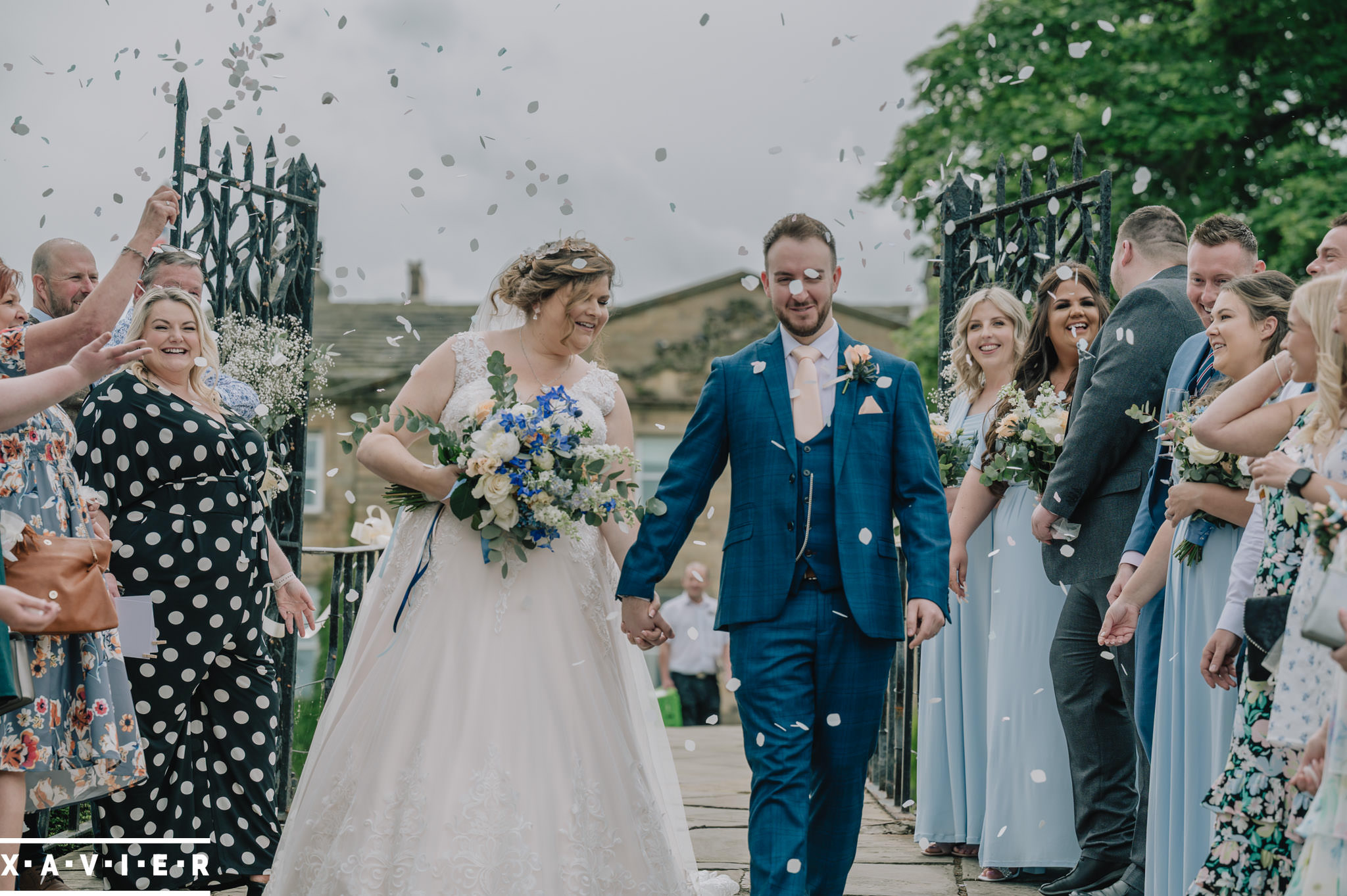 confetti thrown over bride and groom at bridge