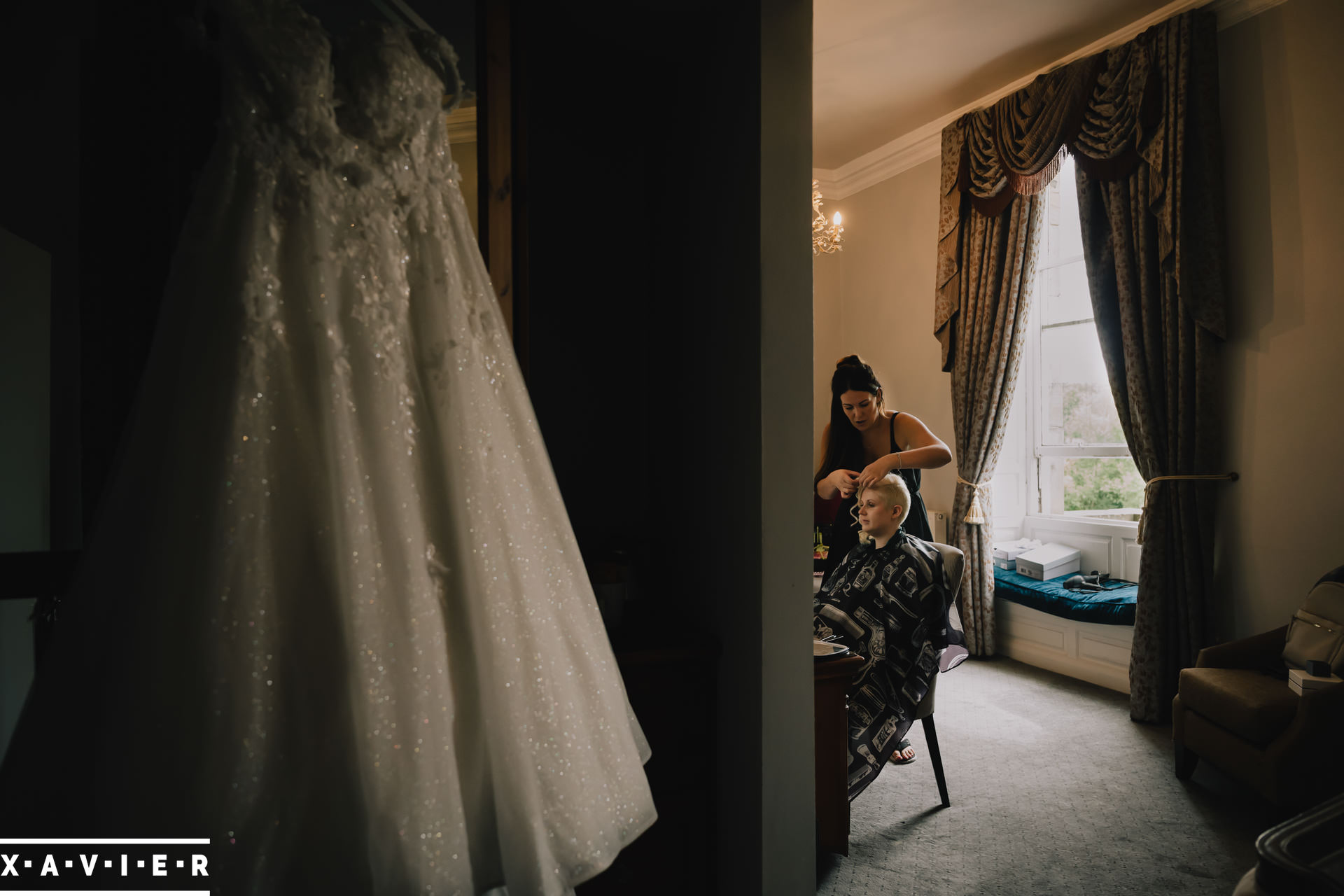 wedding dress hanging as bride getting ready