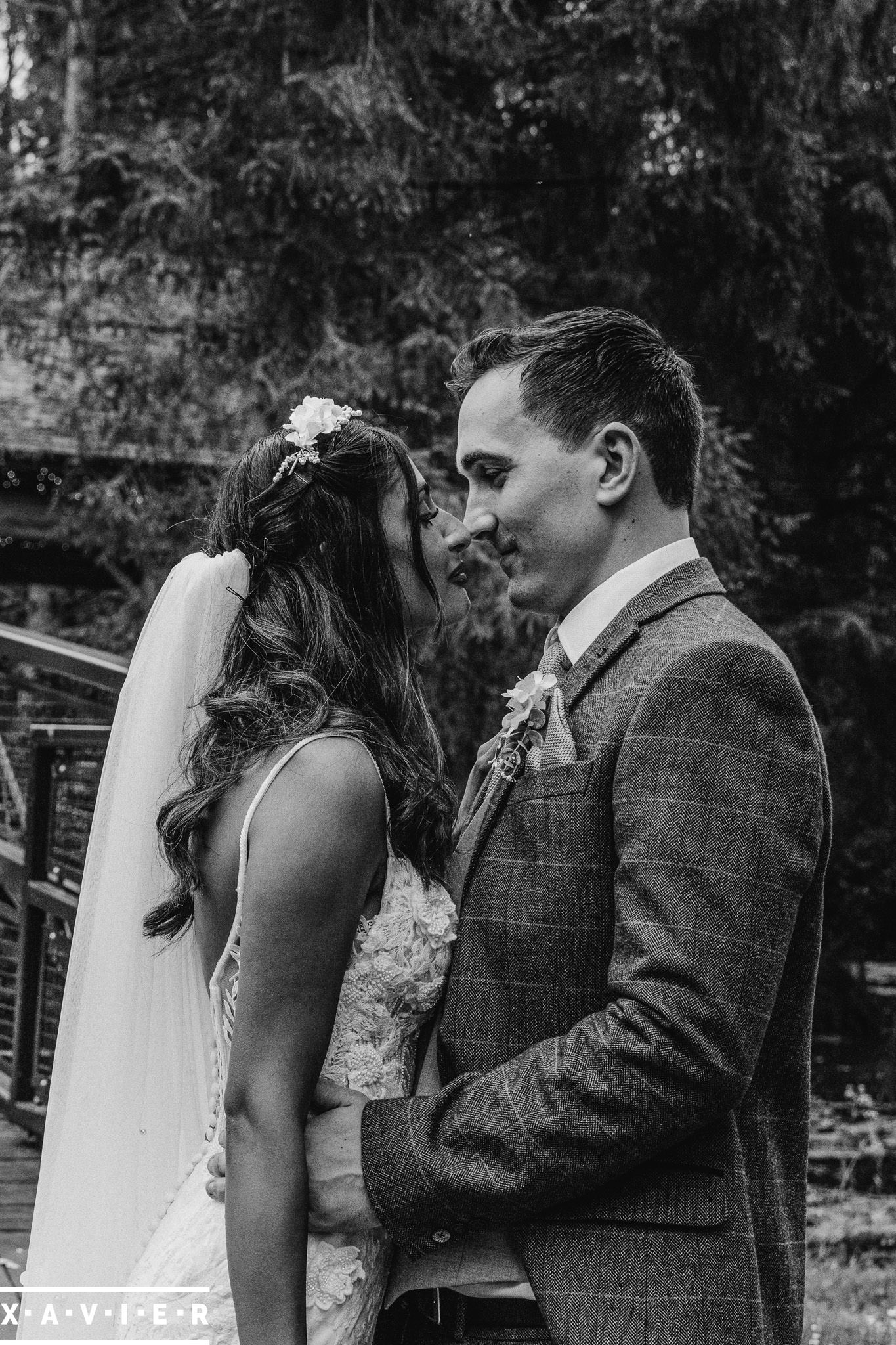 groom holds the brides hand