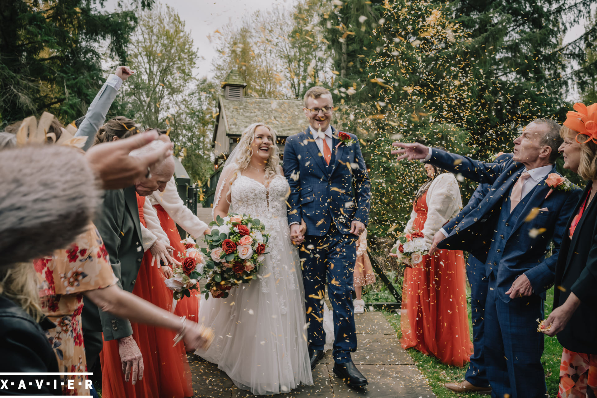 guests throw confetti on the bride and groom