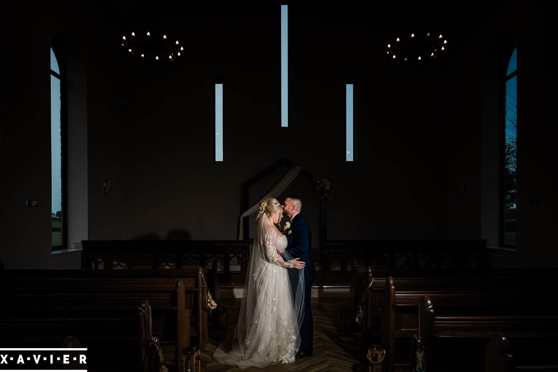 bride and groom pose inthe chapel