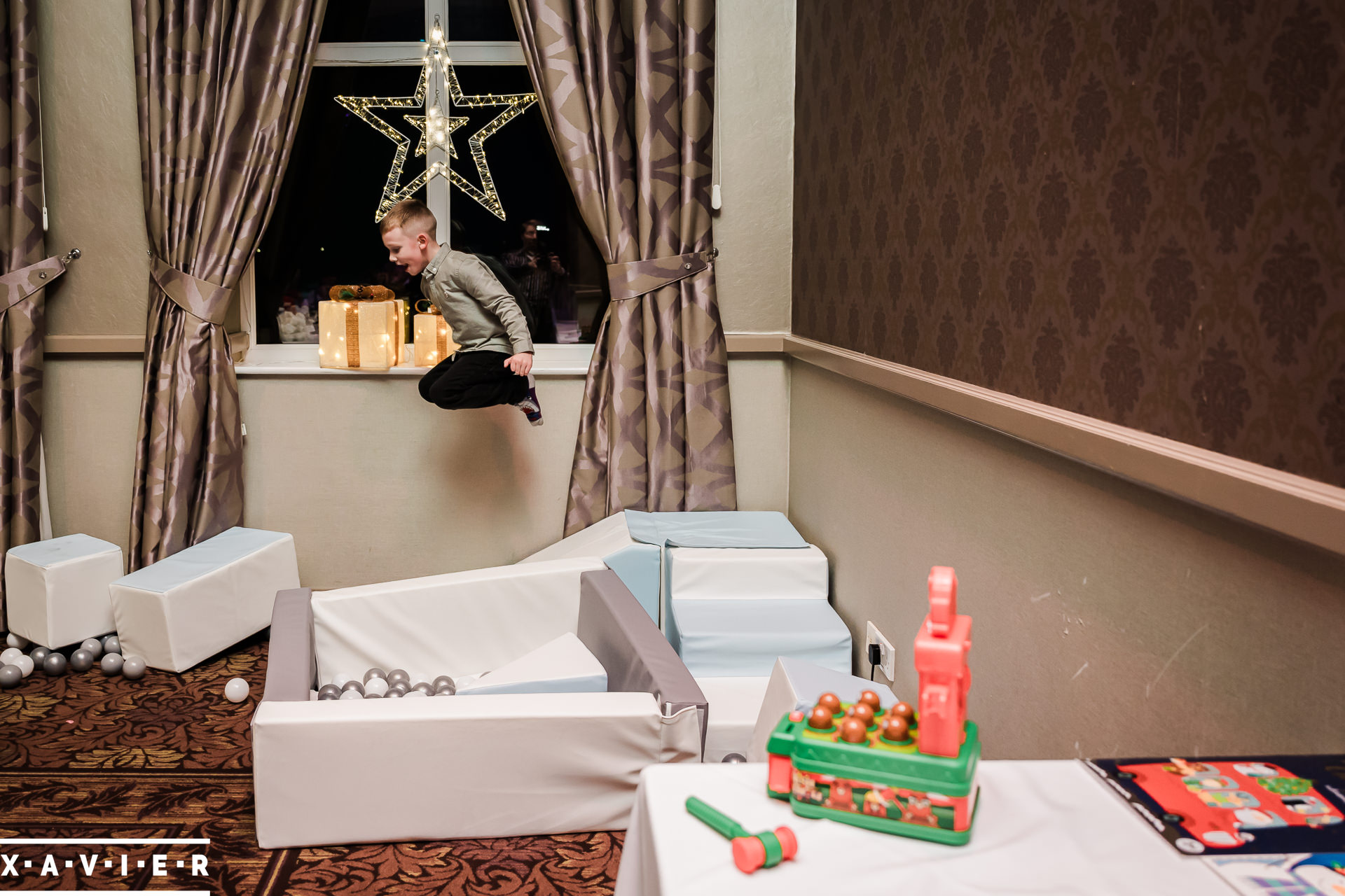 boy bouncing in soft play area