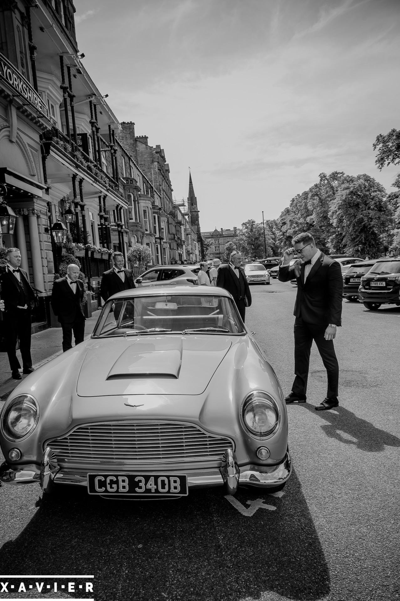 suprised groom admires wedding car