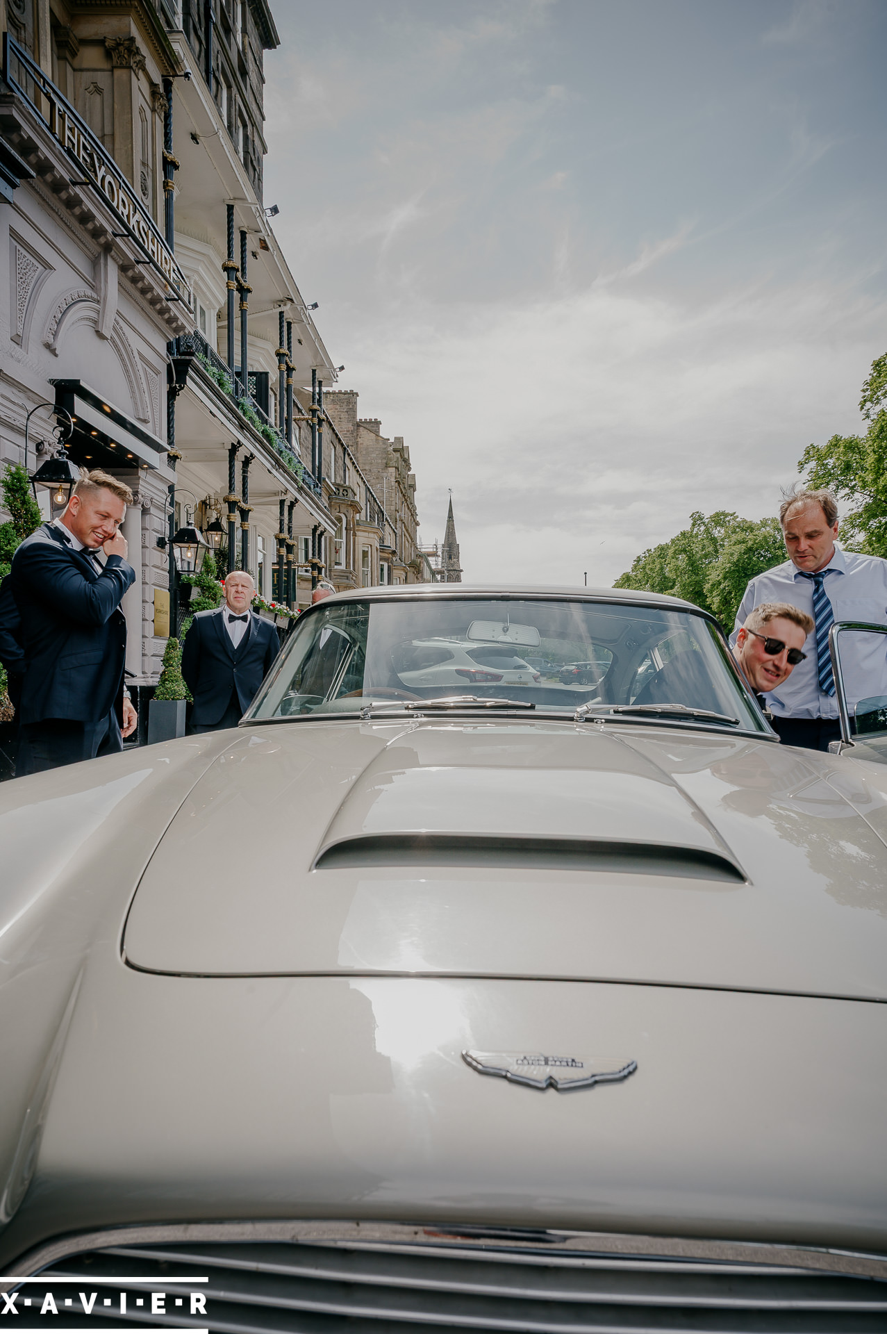 groom getting into wedding car