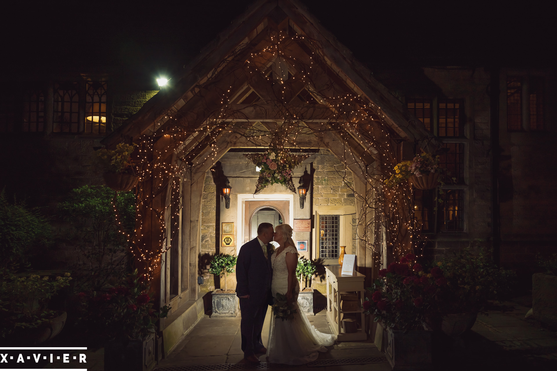 bride groom stand under the porch in the dark
