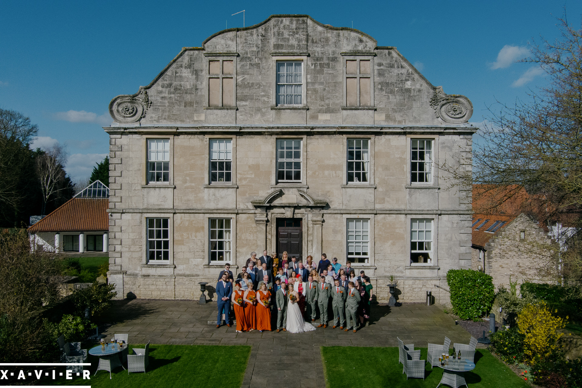 drone photos of wedding party at the front of Hellaby Hall