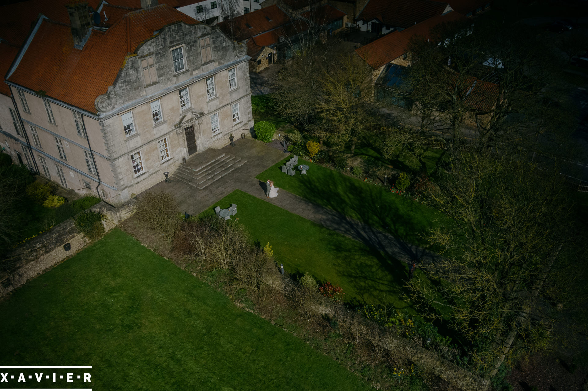 drone photo of bride and groom walking