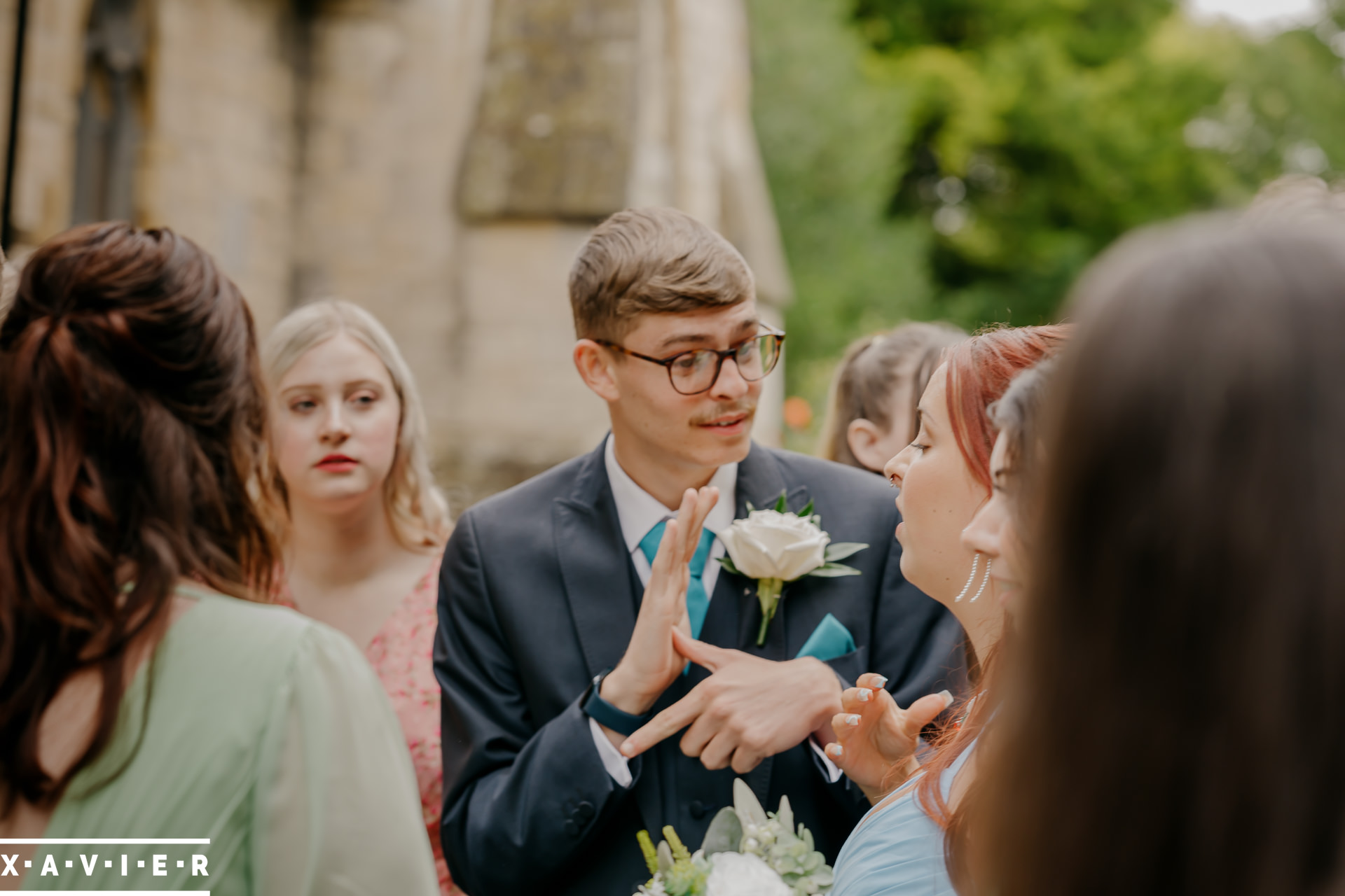 groomsmen is signing to other guests