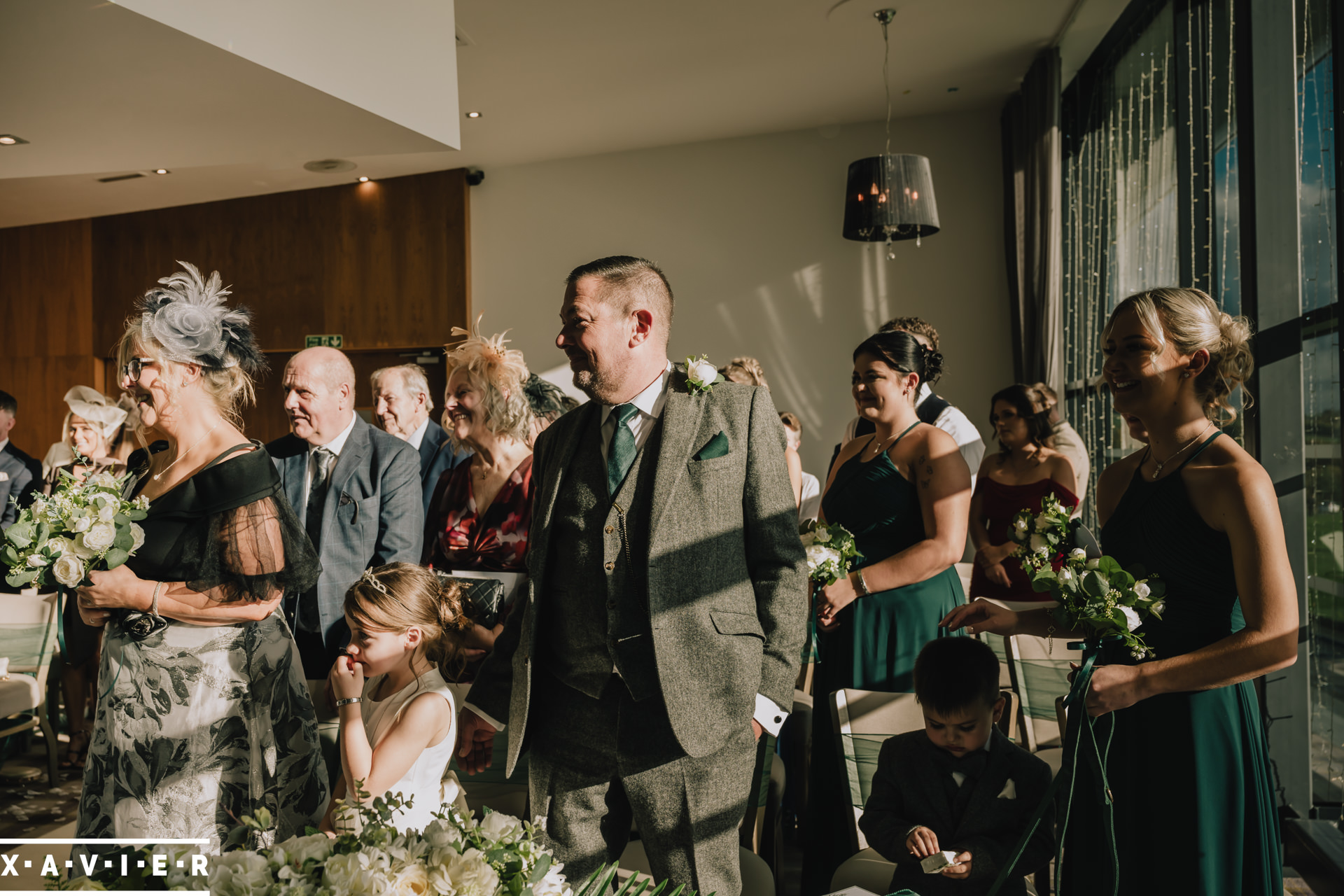 Guests look on at the bride and groomduring the ceremony 