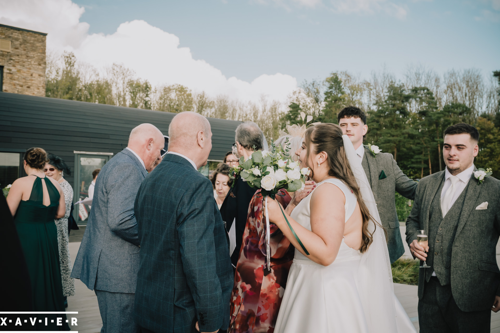 bride and groom are congratulated by their guests