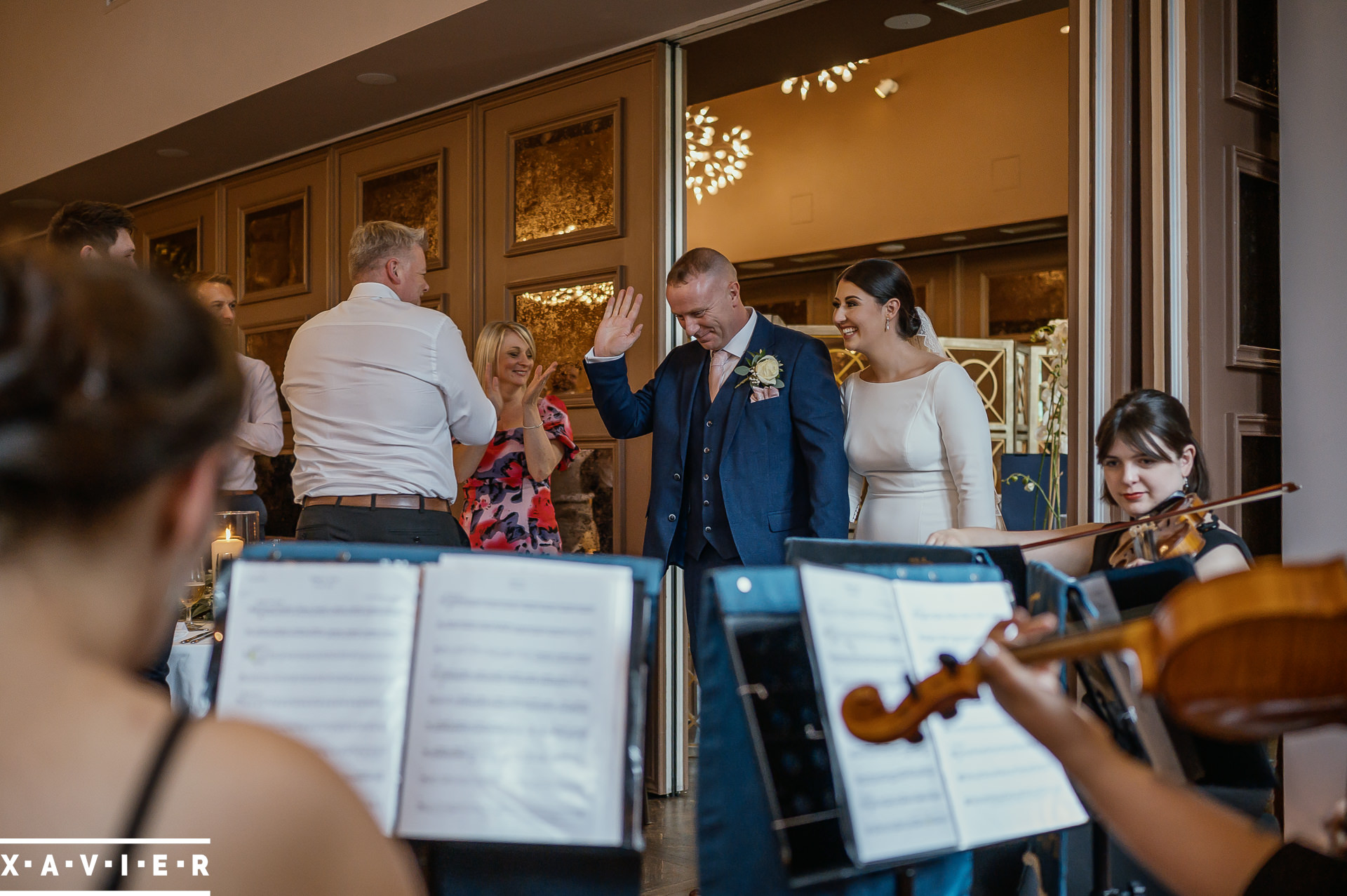 bride and groom walk into the wedding breakfast