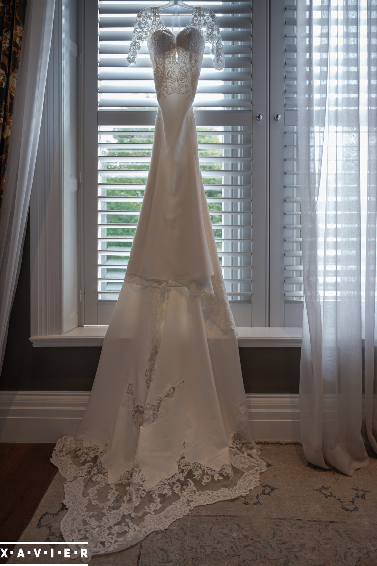 wedding dress hangs in the window