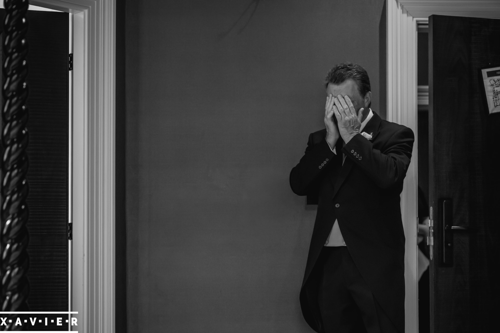 father of the bride covers his tears