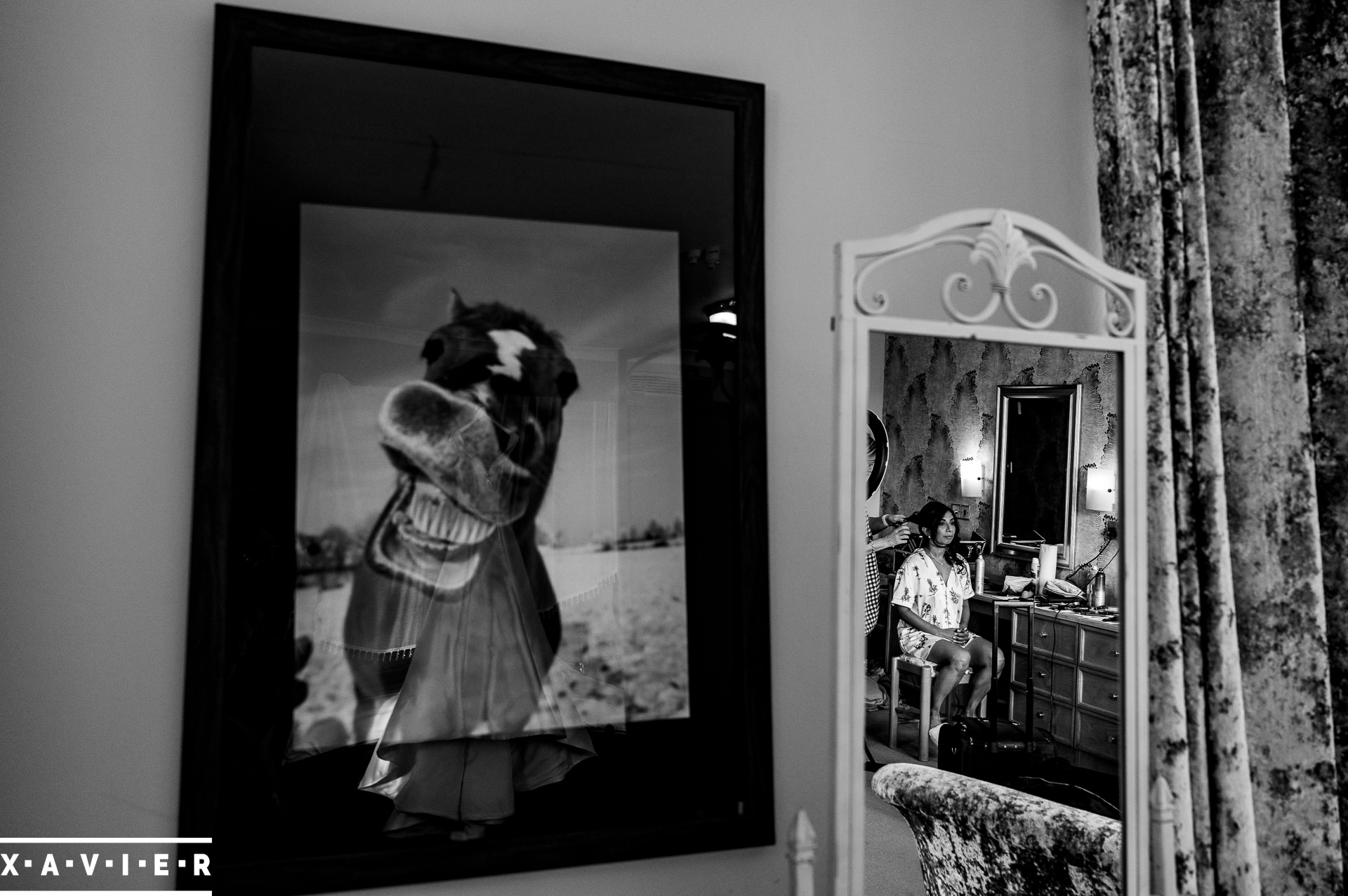 bride is seen in the mirror