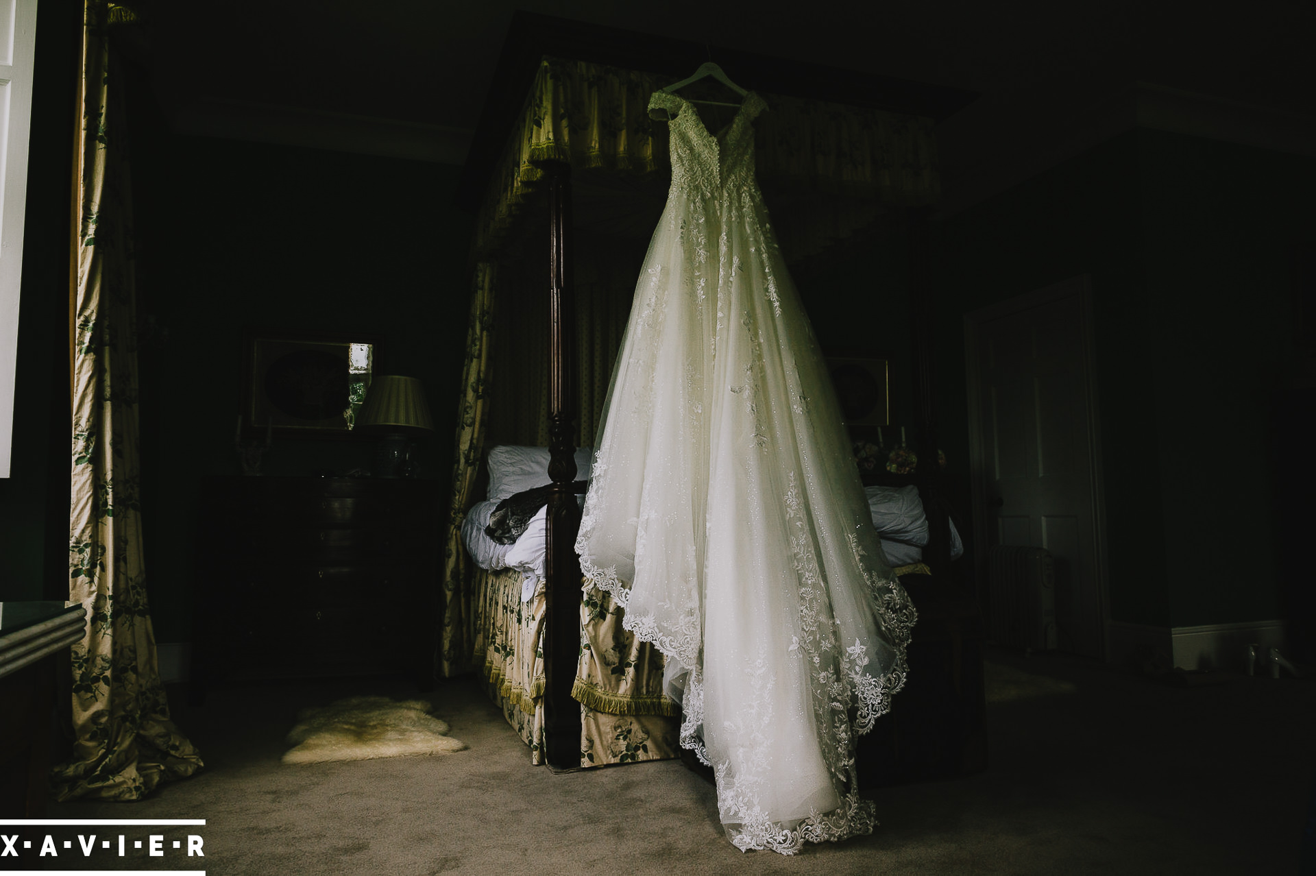wedding dress hangs in the dressing room