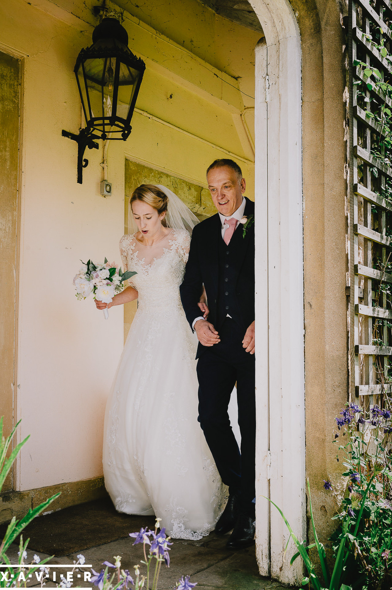 Bride walks into the courtyard with the father of the bride