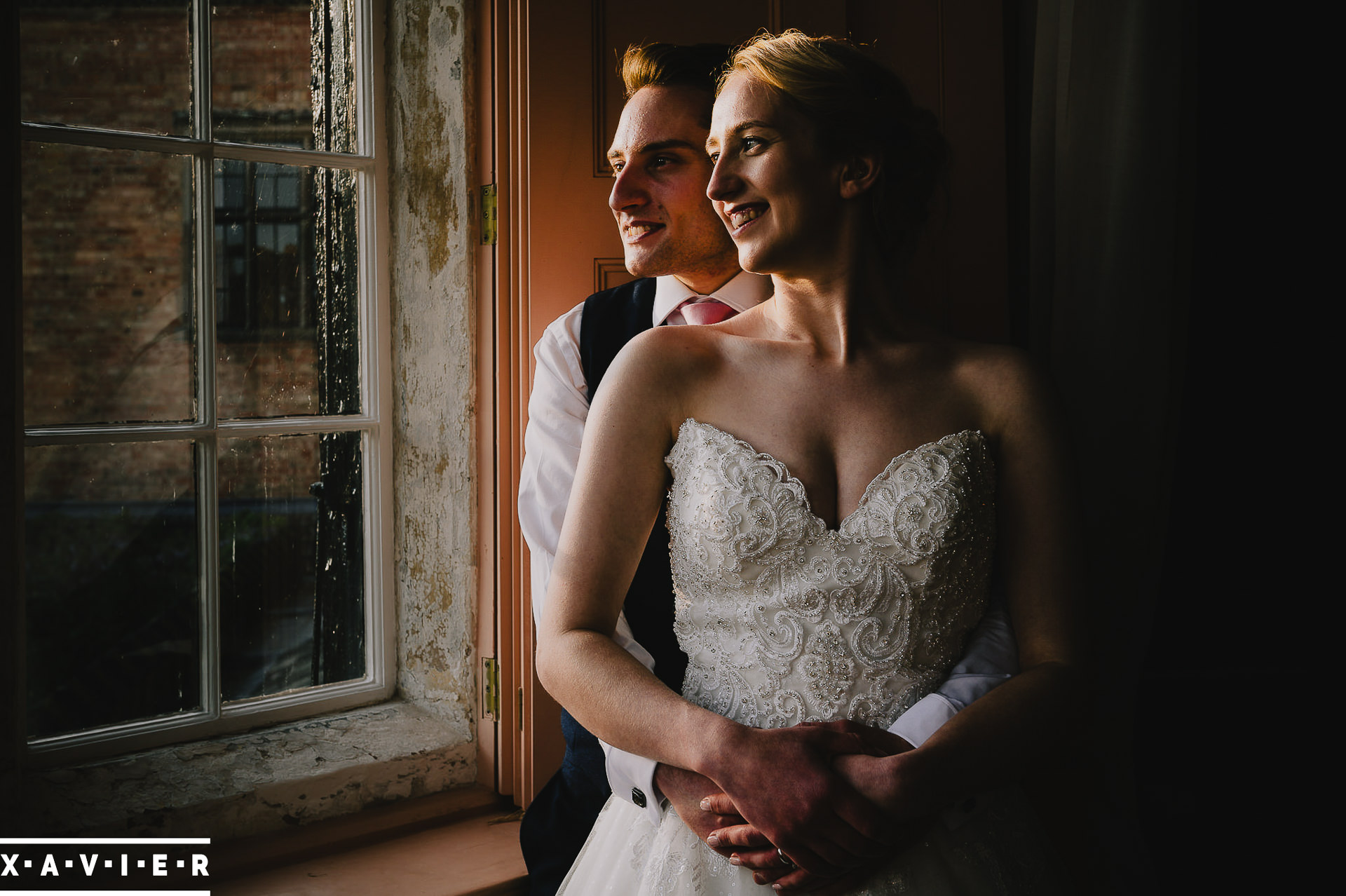 bride and groom look out of the window