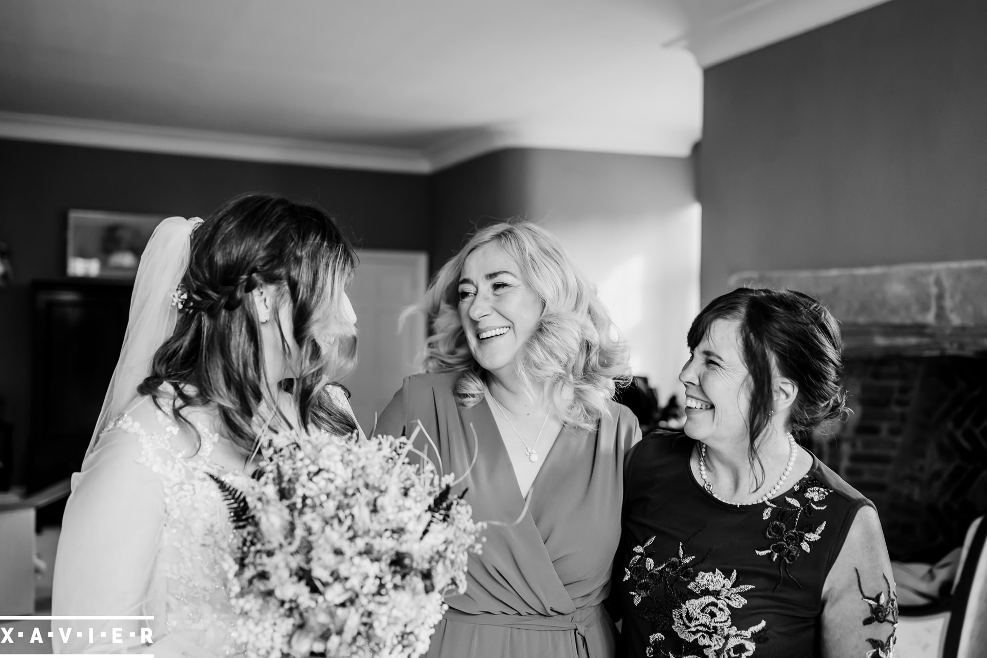bride laughing with mother and mother-in-law