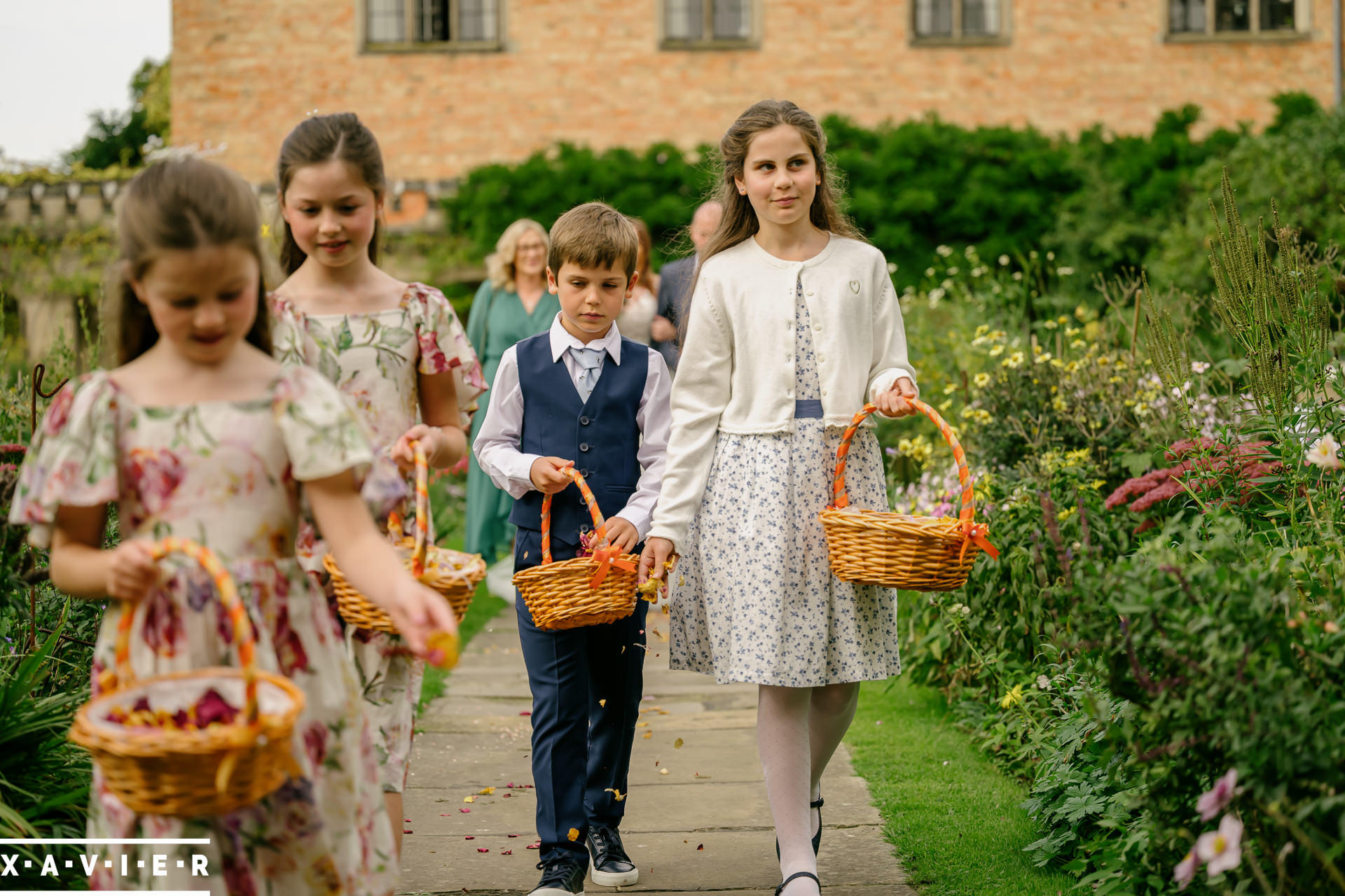 petals are scattered in fornt of the bride