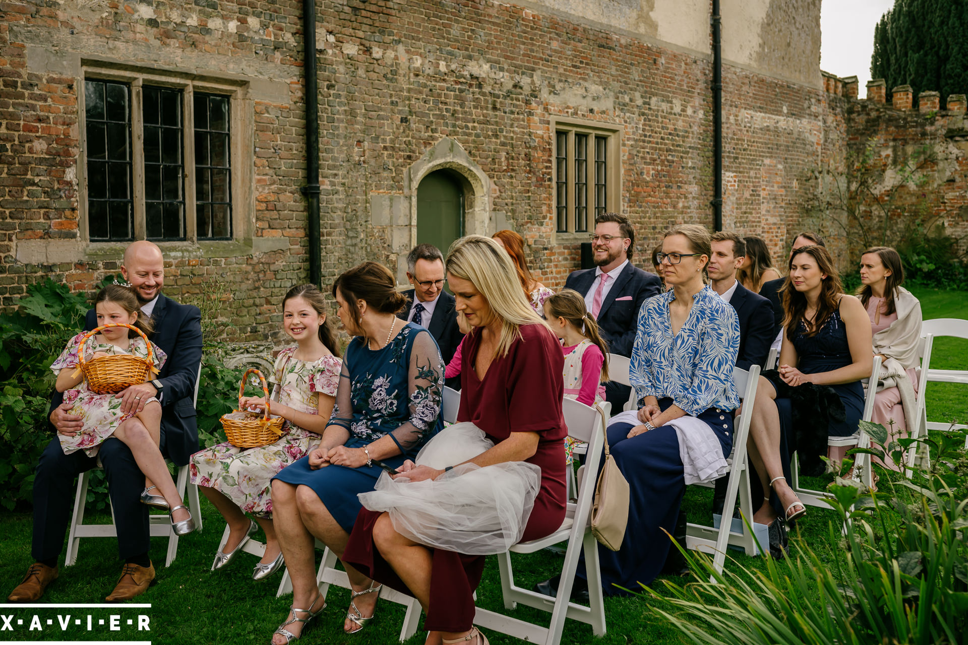 a guest holds the brides veil ater it blew off
