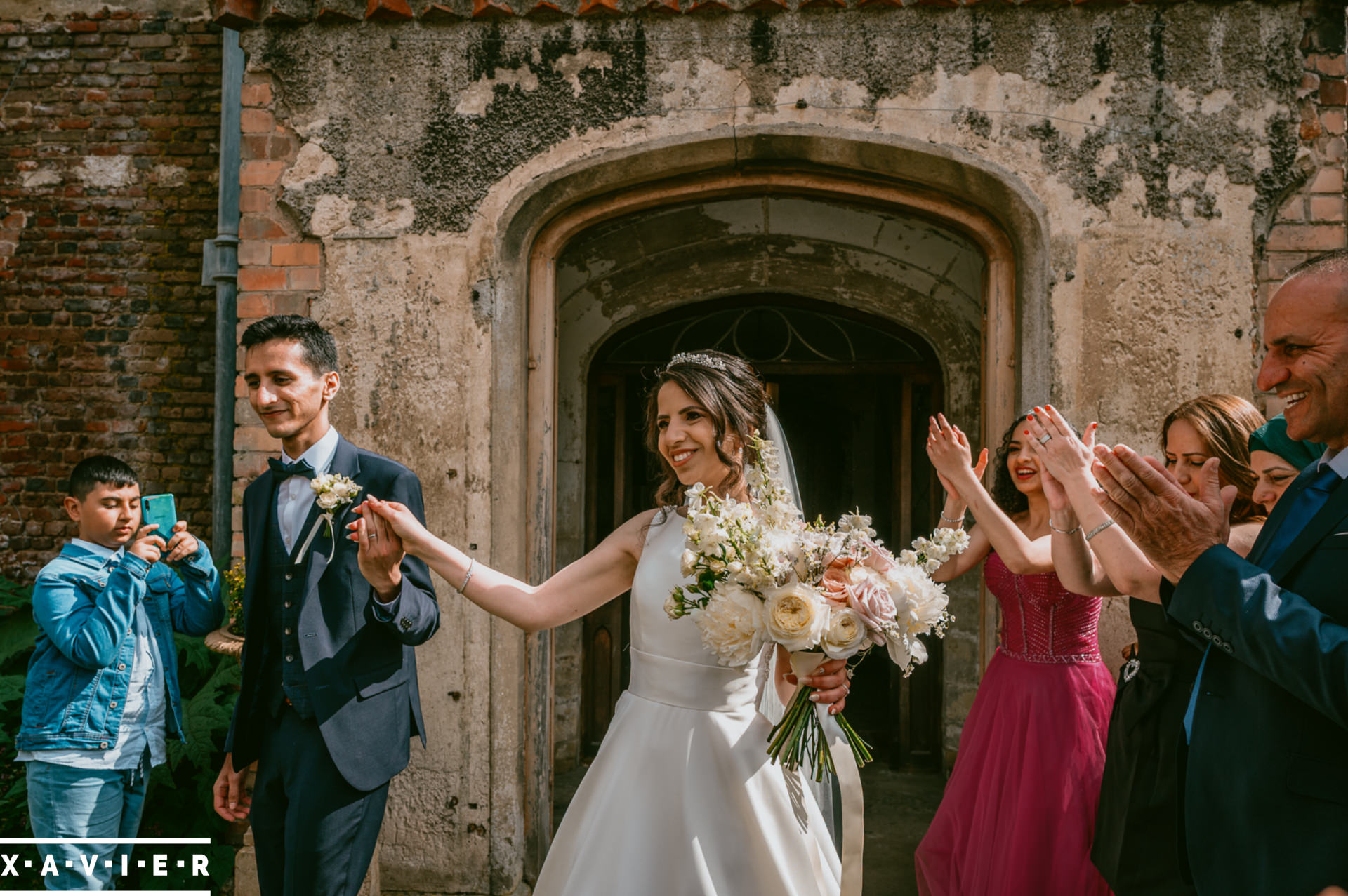 bride and groom walk from the ceremony as a married couple