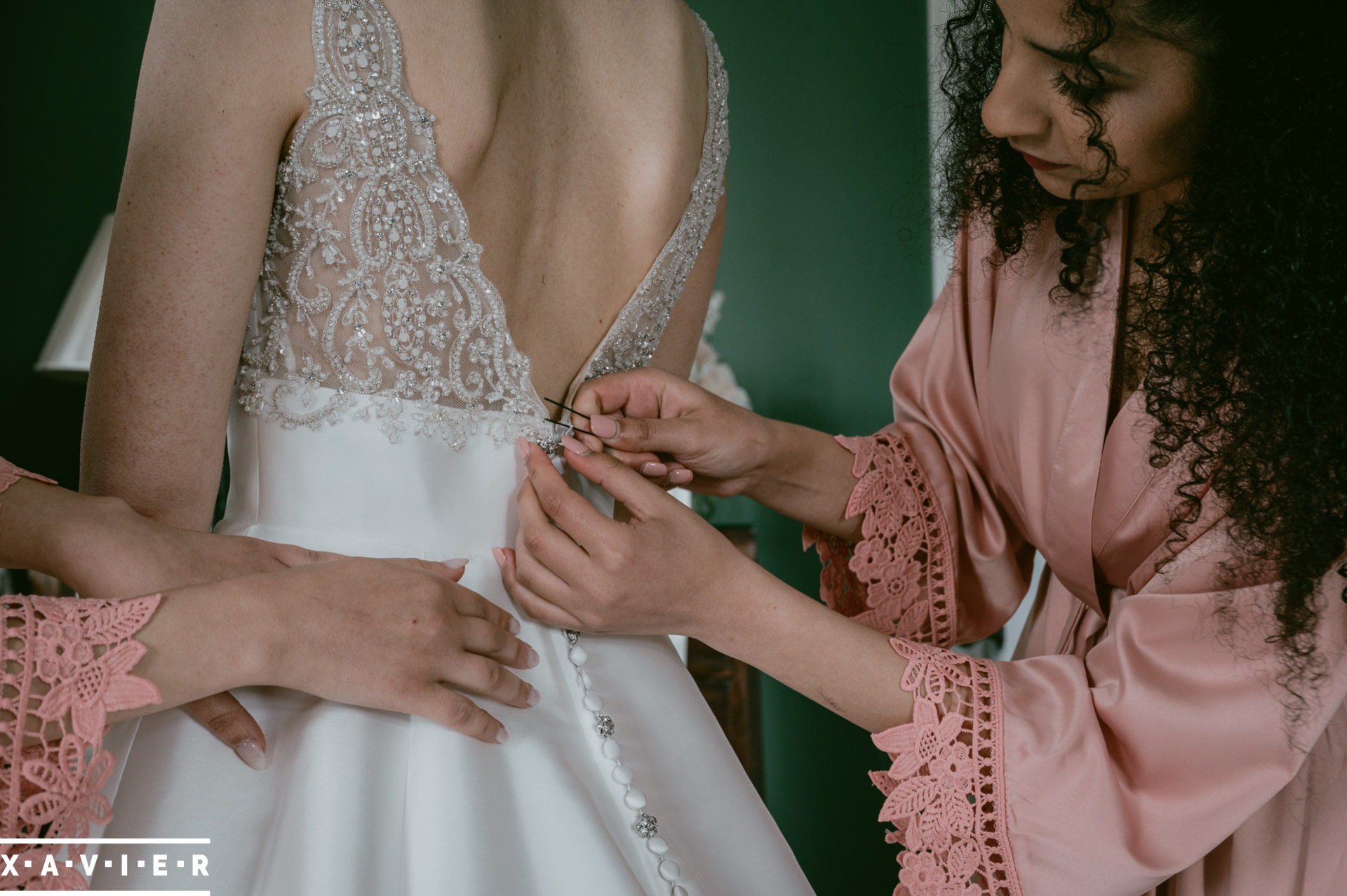 bride has her dress fastened