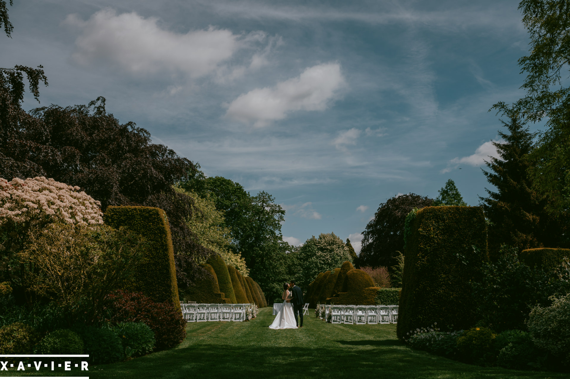 bride and groom walk in the gardens