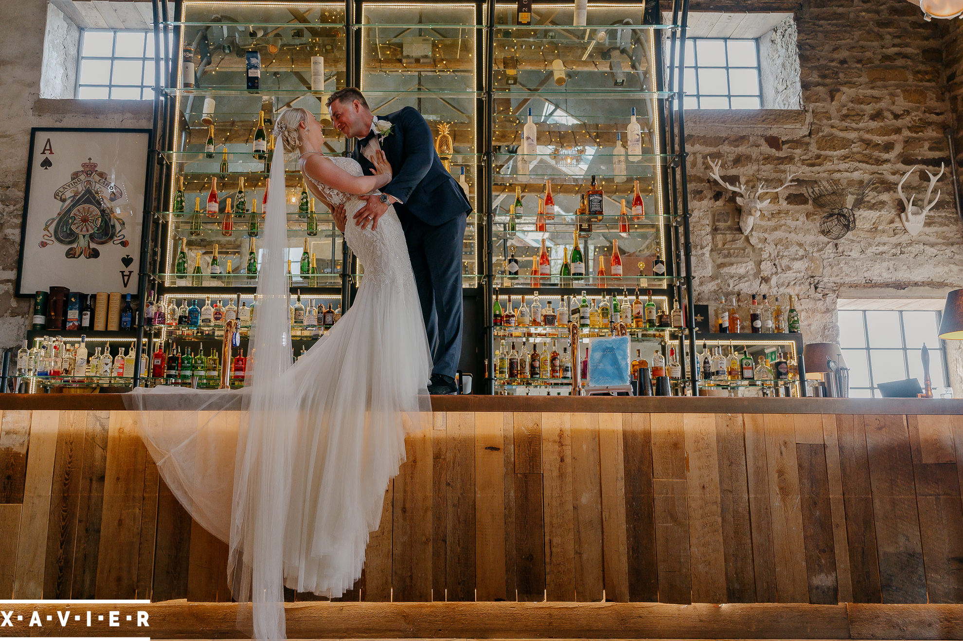 groom dips the bride on the bar