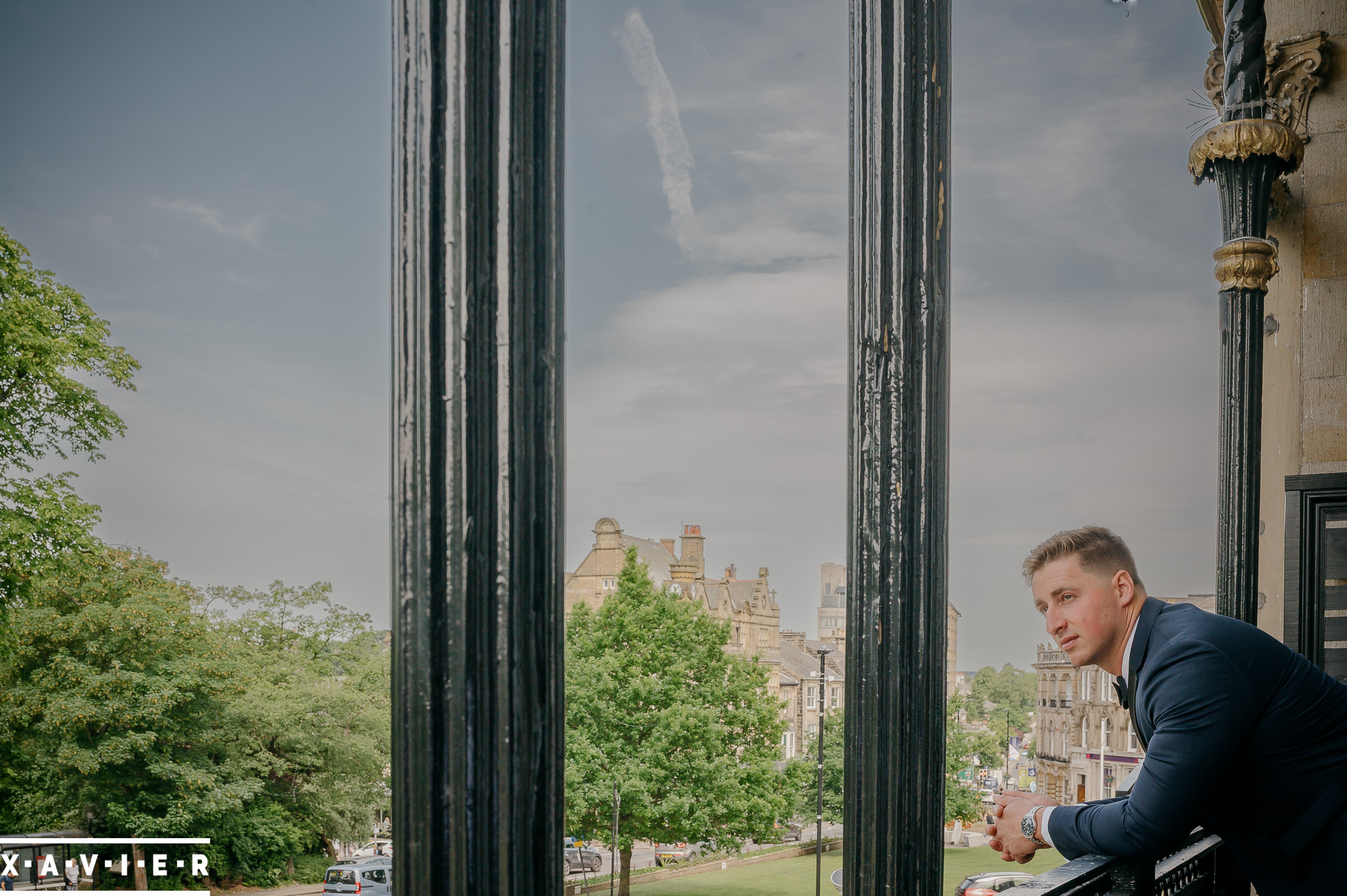 ghroom leans on the hotel balcony