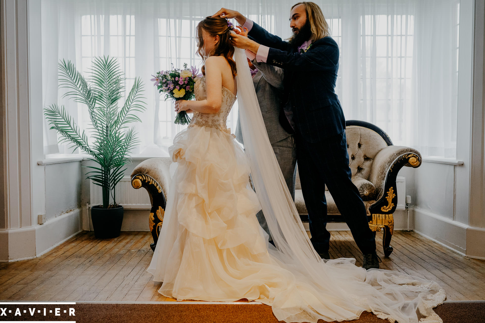 putting on the brides veil