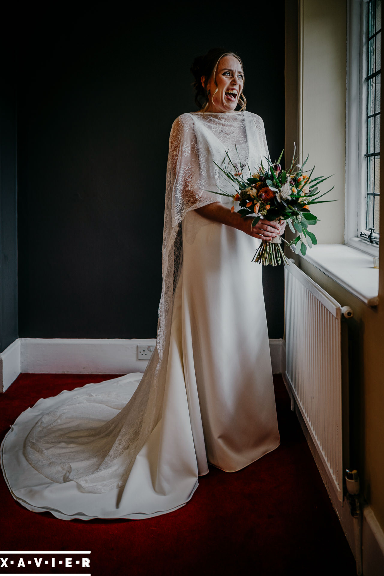 bride holding her flowers and looking out of the window